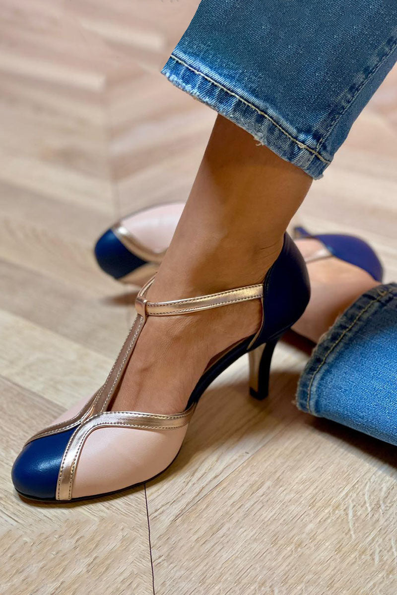 Dark blue pointed-toe heels with thin ankle strap and stiletto heel