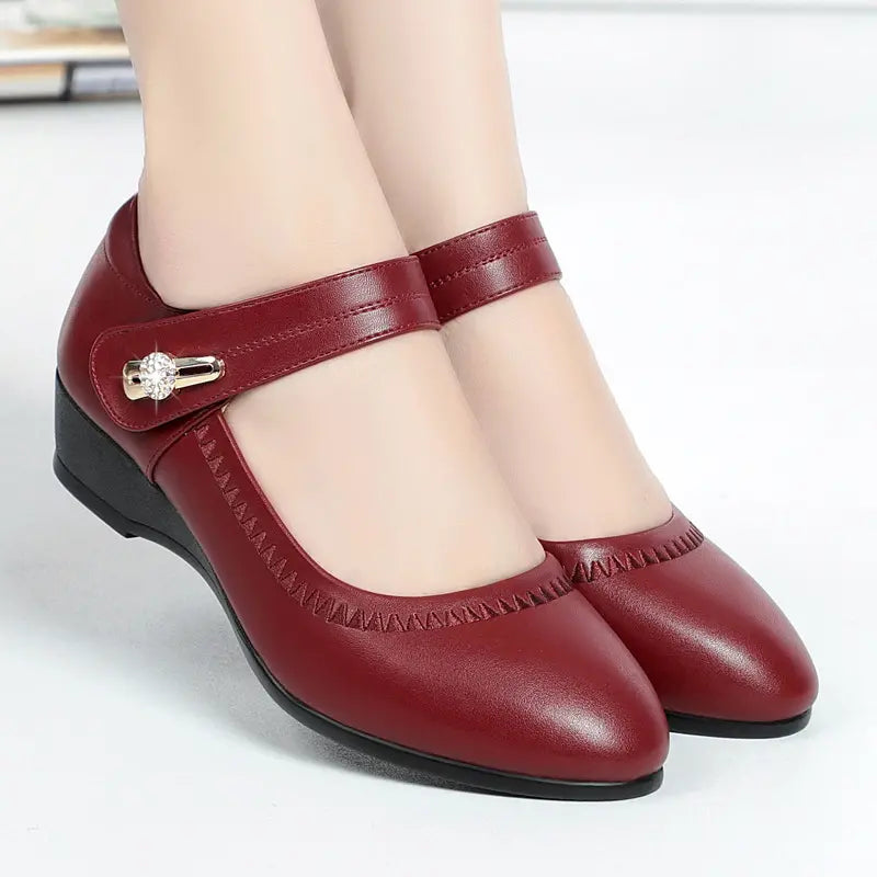 Red mid-heel Mary Jane shoes with T-strap, stitched trim, and jewel buckle