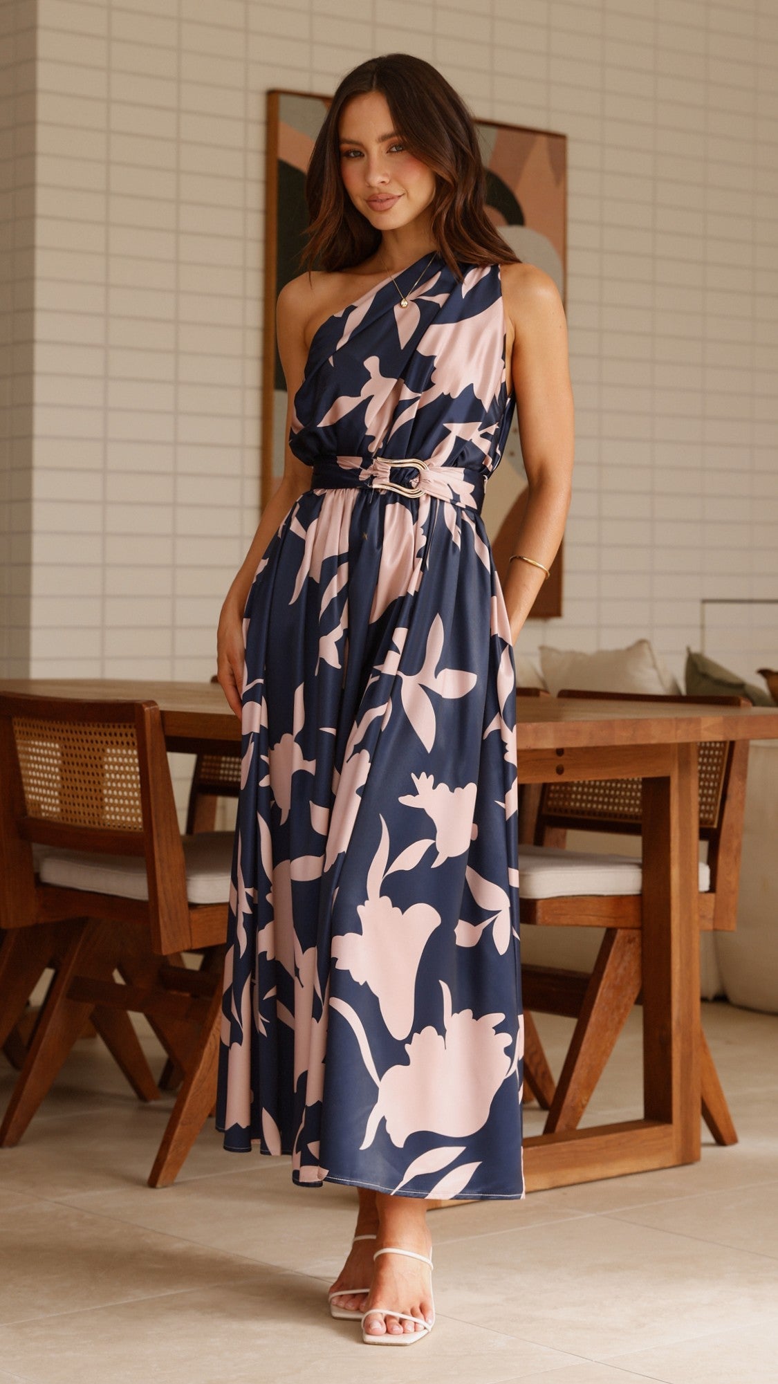 Navy maxi dress with pink floral print, sleeveless, belted waist, full length front view.