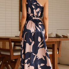 Navy maxi dress with pink floral print, open back, belted waist, back view.
