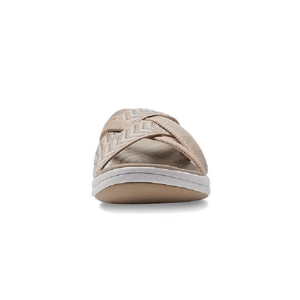 Beige sandal front with chevron straps over open toe and cushioned midsole.