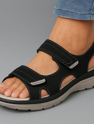 Black orthopaedic support sandal with adjustable hook-and-loop straps and cushioned sole