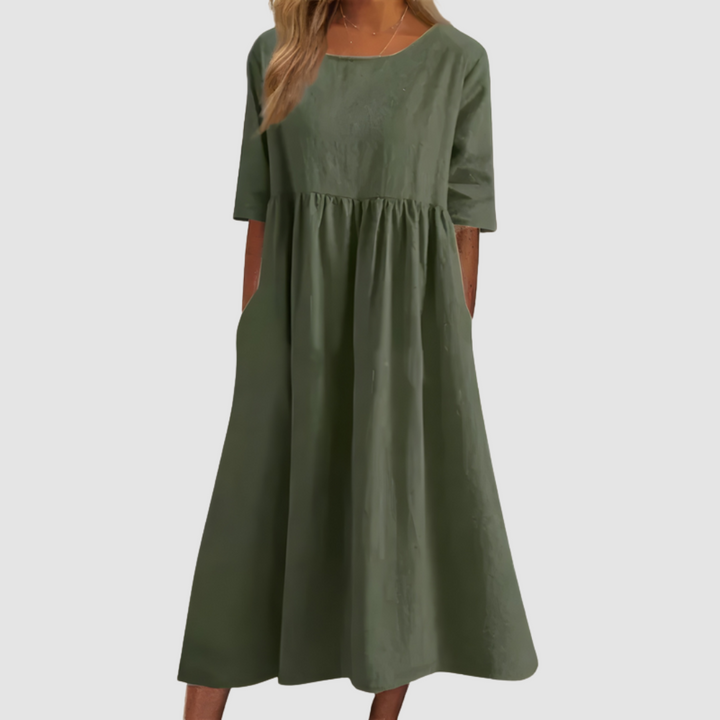 Green breezy dress with gathered waist and short sleeves, flowy A-line silhouette