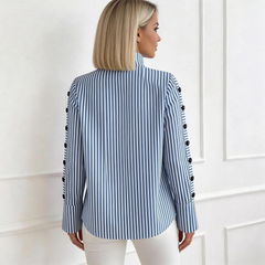 Blue-and-white striped high-neck long-sleeve top with buttoned cuffs, back view.