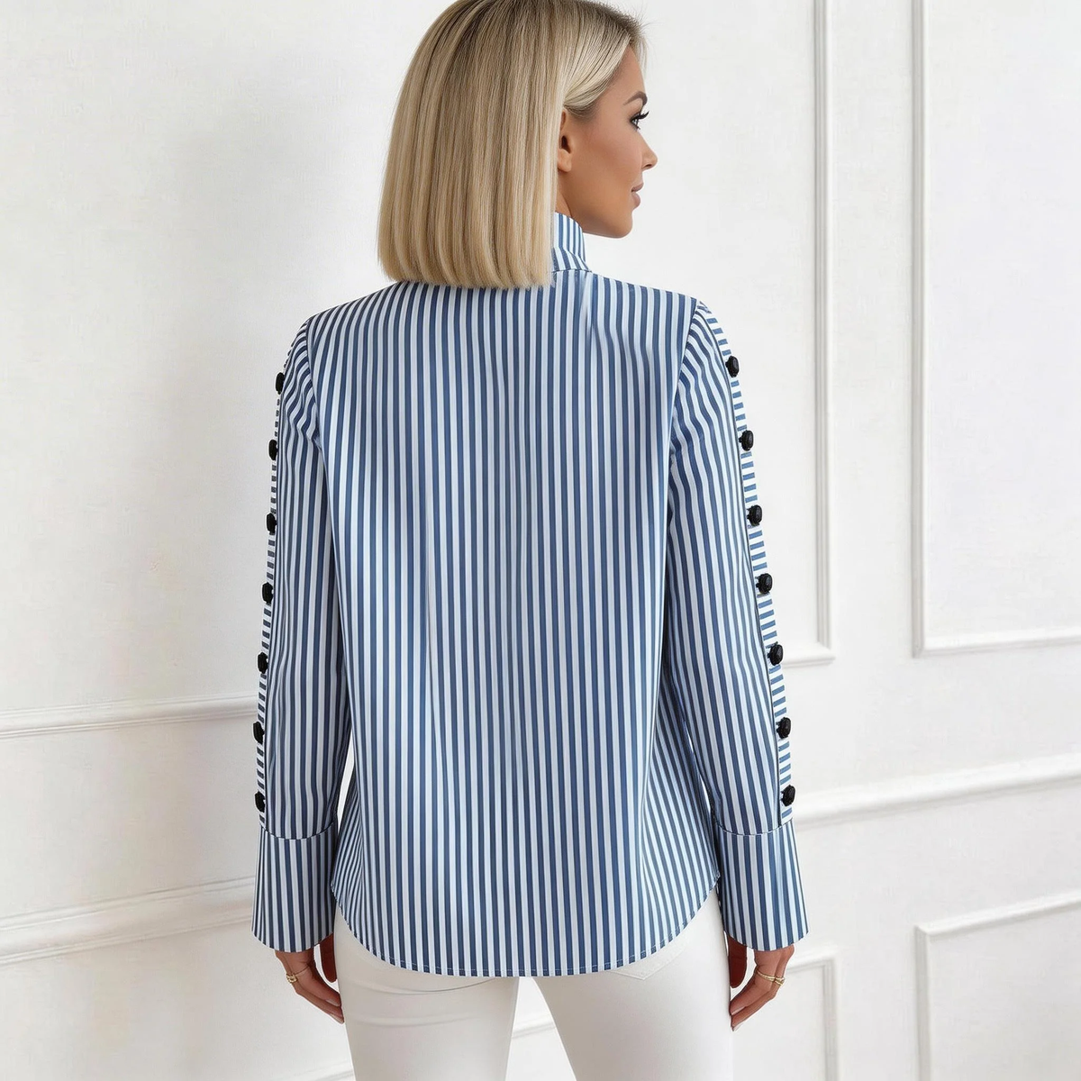 Blue-and-white striped high-neck long-sleeve top with buttoned cuffs, back view.