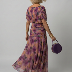 Purple floral off-shoulder flow midi dress from back, elastic waist and full skirt