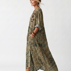 Green patterned oversized midi dress, button front and patch pockets, side view with asym hem