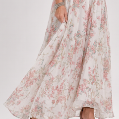 Floral halter midi dress skirt with tiered gathers and flowing hem, showing high-heel sandals