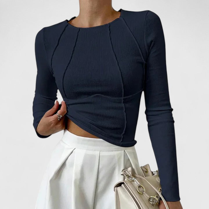 Dark navy long-sleeve knit top with crew neck and draped ruched front; fitted cropped hem