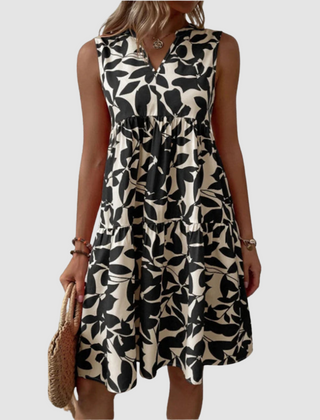 Black and white sleeveless V-neck flowy dress with leaf-pattern print and gathered skirt