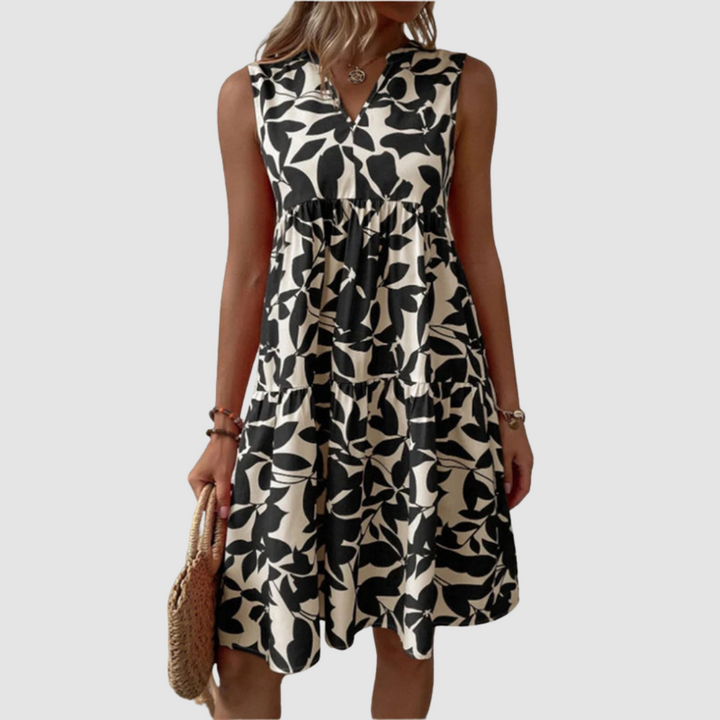 Black and white sleeveless V-neck flowy dress with leaf-pattern print and gathered skirt