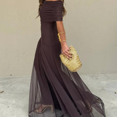 Dark plum off-shoulder maxi dress with ruched neckline and layered, sheer hem