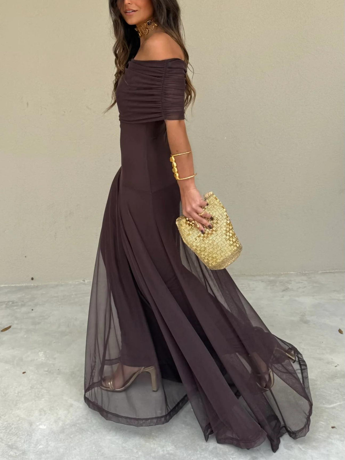 Dark plum off-shoulder maxi dress with ruched neckline and layered, sheer hem