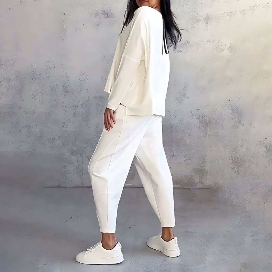 White two-piece lounge set with draped long-sleeve top and tapered jogger pants