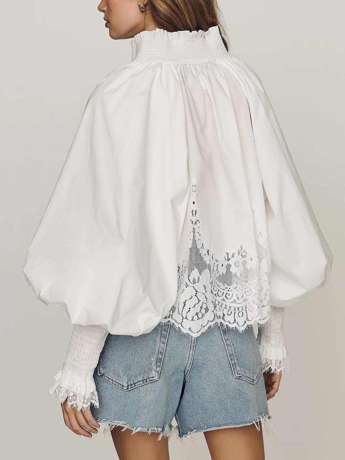 White lace blouse back view with gathered high neck and scalloped lace panel