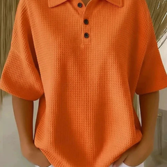 Orange waffle knit polo blouse with short sleeves, pointed collar, three-button placket