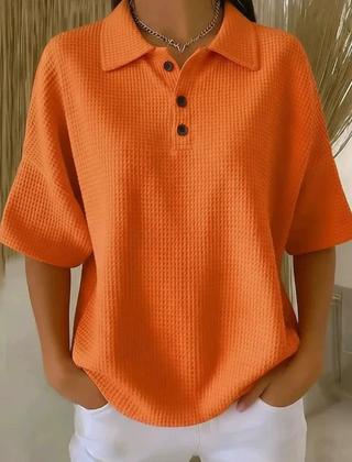 Orange waffle knit polo blouse with short sleeves, pointed collar, three-button placket