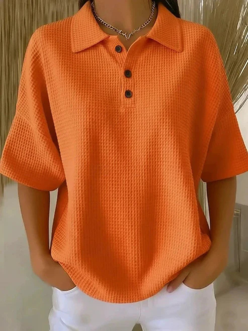 Orange waffle knit polo blouse with short sleeves, pointed collar, three-button placket