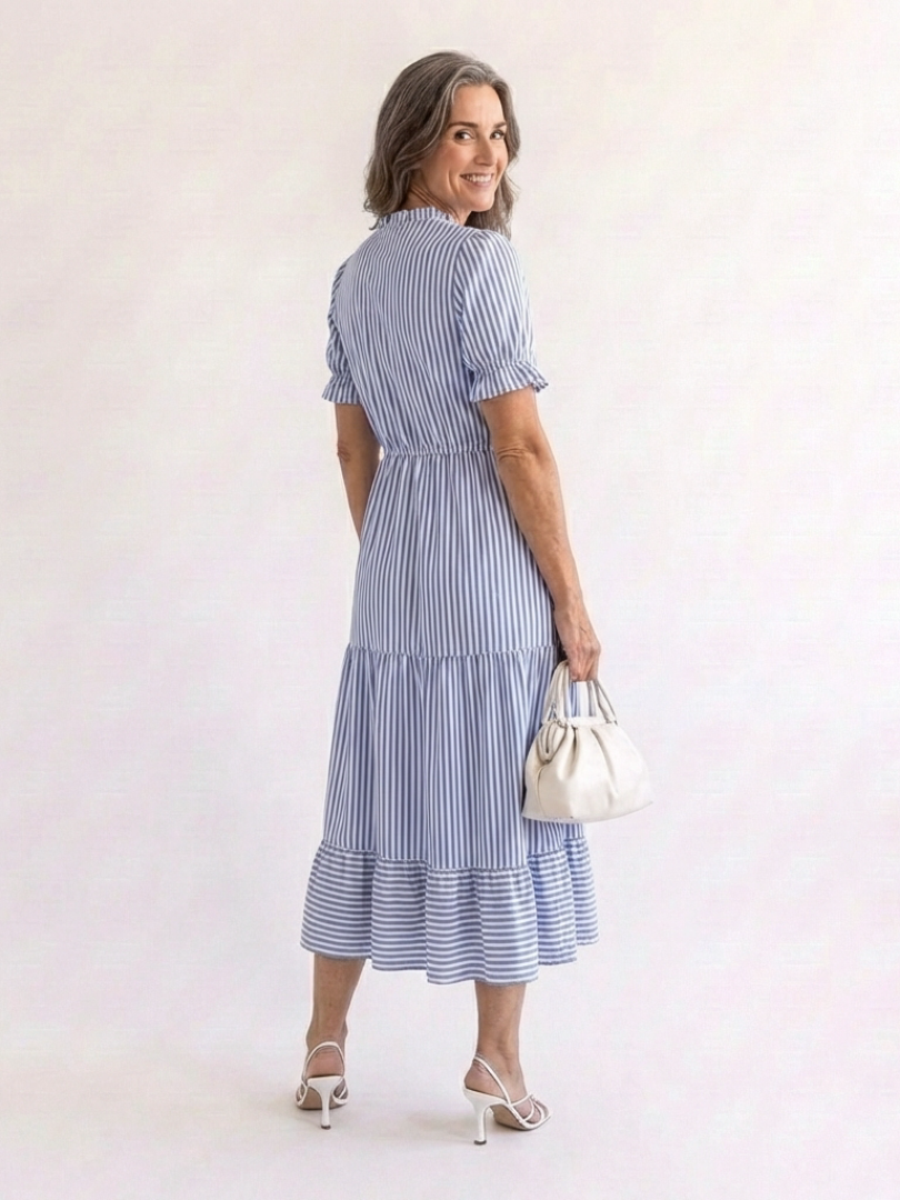 Sky blue striped tiered midi dress with tiered skirt and short puff sleeves, side view