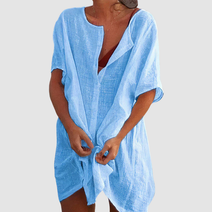 Blue soft loose fit dress with V-neck, short sleeves, and front tie knot.