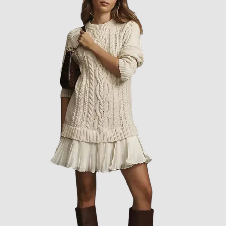 Cream cable knit mini dress with long sleeves, cable pattern bodice, and tiered ruffle hem