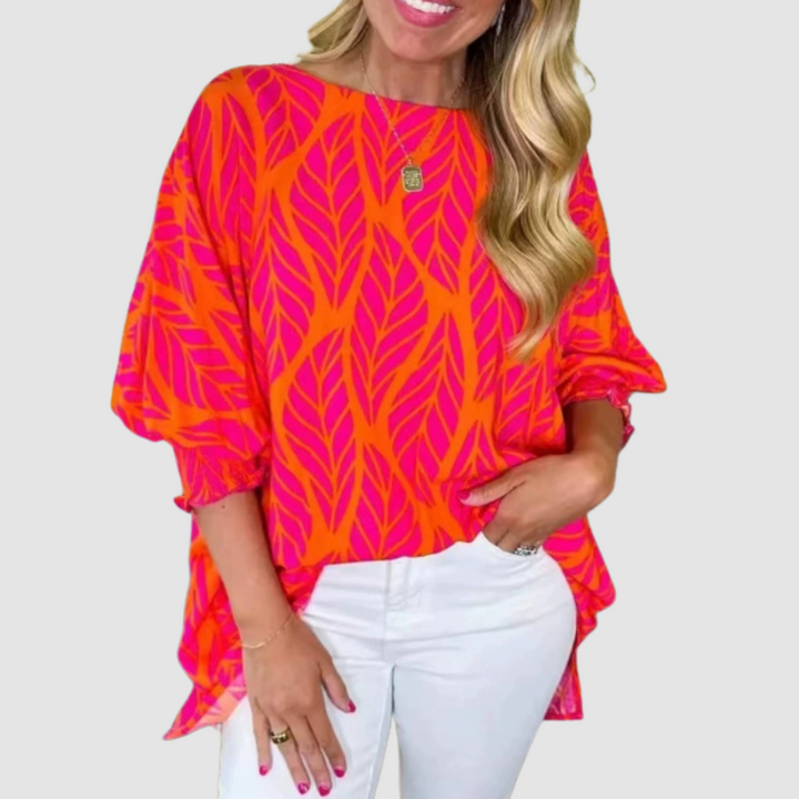 Loose red-orange leaf-print blouse with relaxed short sleeves and rounded neckline