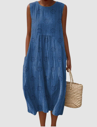 Blue sleeveless midi dress with embroidered eyelet clover pattern, tiered skirt