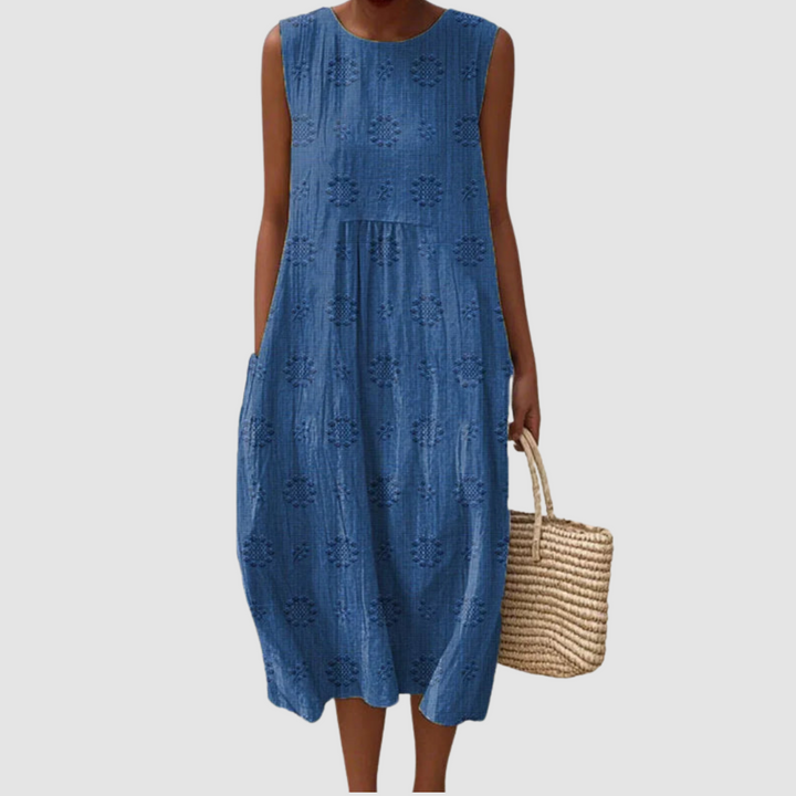Blue sleeveless midi dress with embroidered eyelet clover pattern, tiered skirt