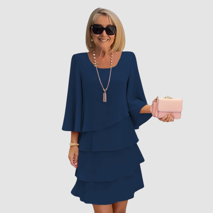Blue layered short dress with long sleeves and scoop neckline, tiered skirt.