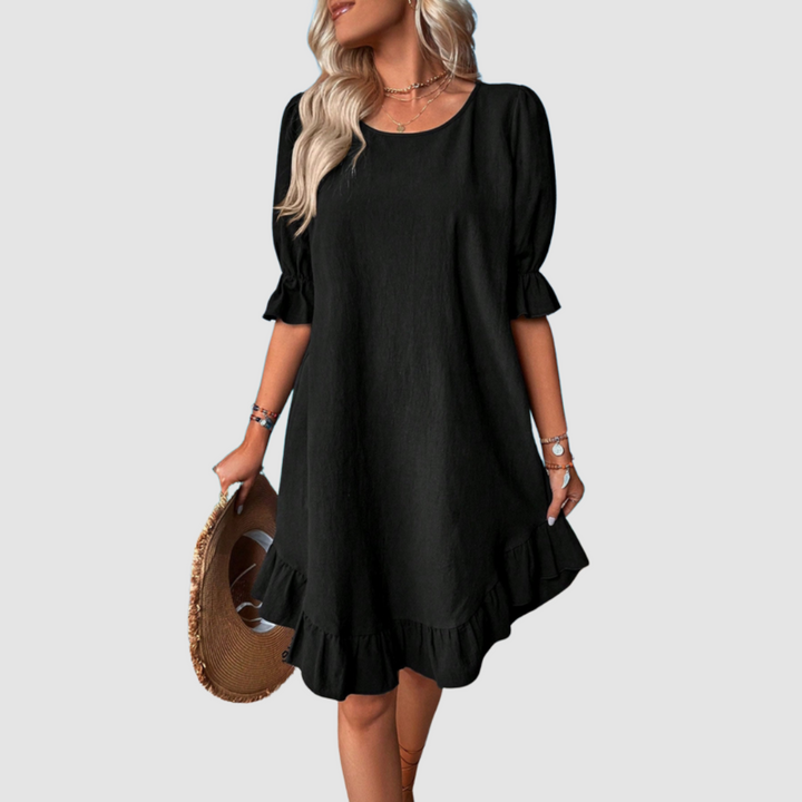 Black flowy summer dress with half sleeves and gathered ruffle hem.