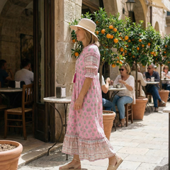 Pink boho tiered midi dress with short sleeves and allover floral print