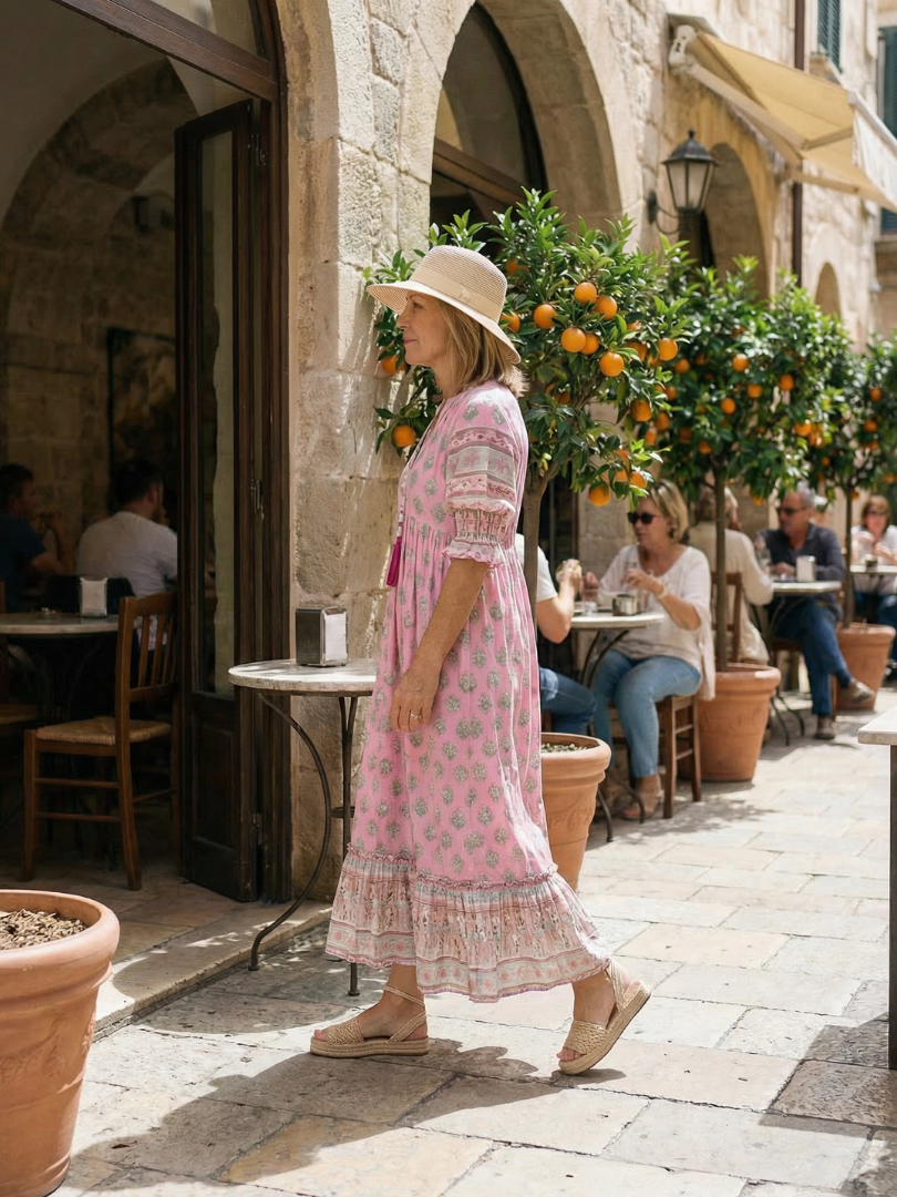 Pink boho tiered midi dress with short sleeves and allover floral print
