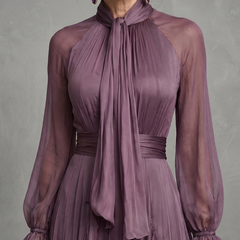 Purple tie-neck maxi dress with layered ruffles, sheer long sleeves, and belted waist