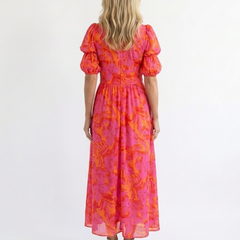 Pink floral midi dress back view with puff sleeves and gathered waist