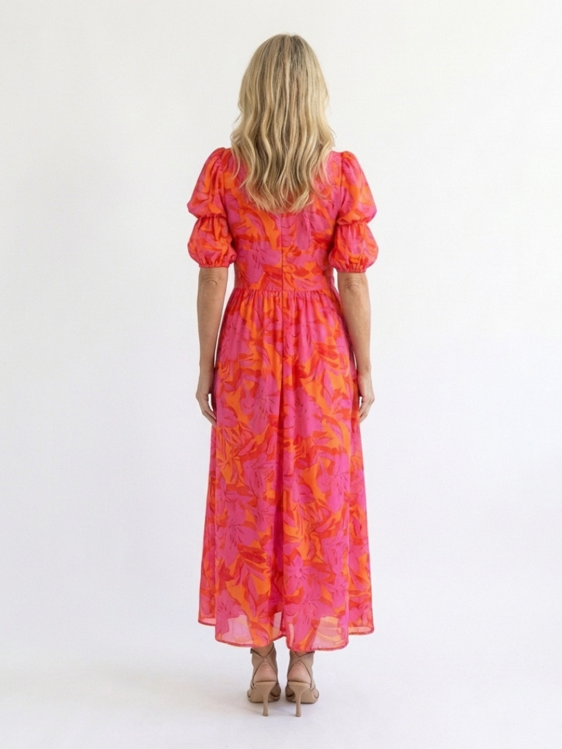 Pink floral midi dress back view with puff sleeves and gathered waist