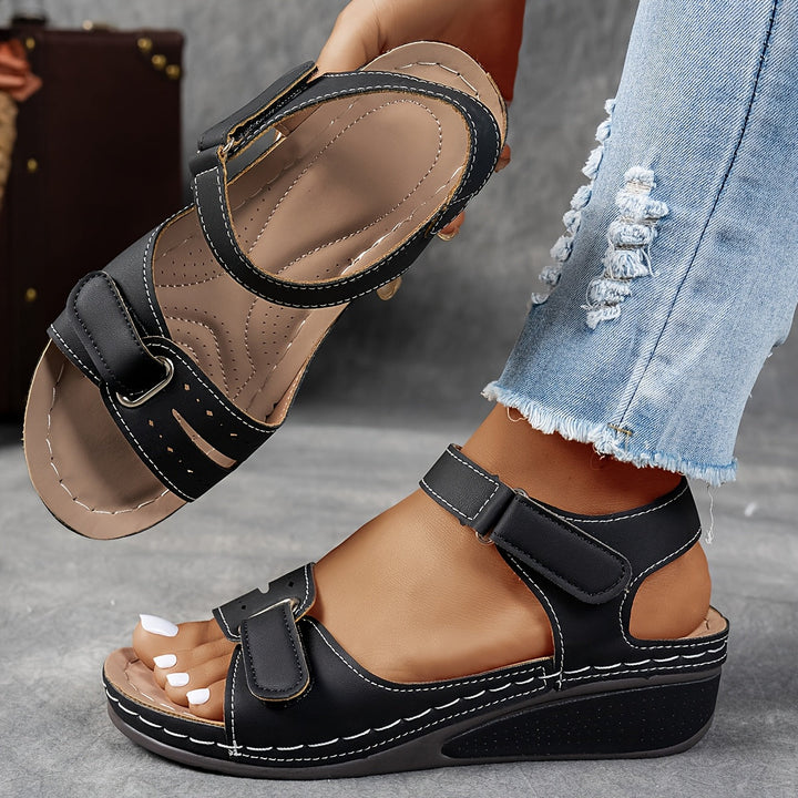 Black orthopedic sandal with adjustable Velcro straps, open toe, padded cushioned footbed.