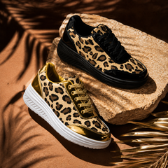Leopard print platform sneakers on stone: black lace pair and gold lace pair