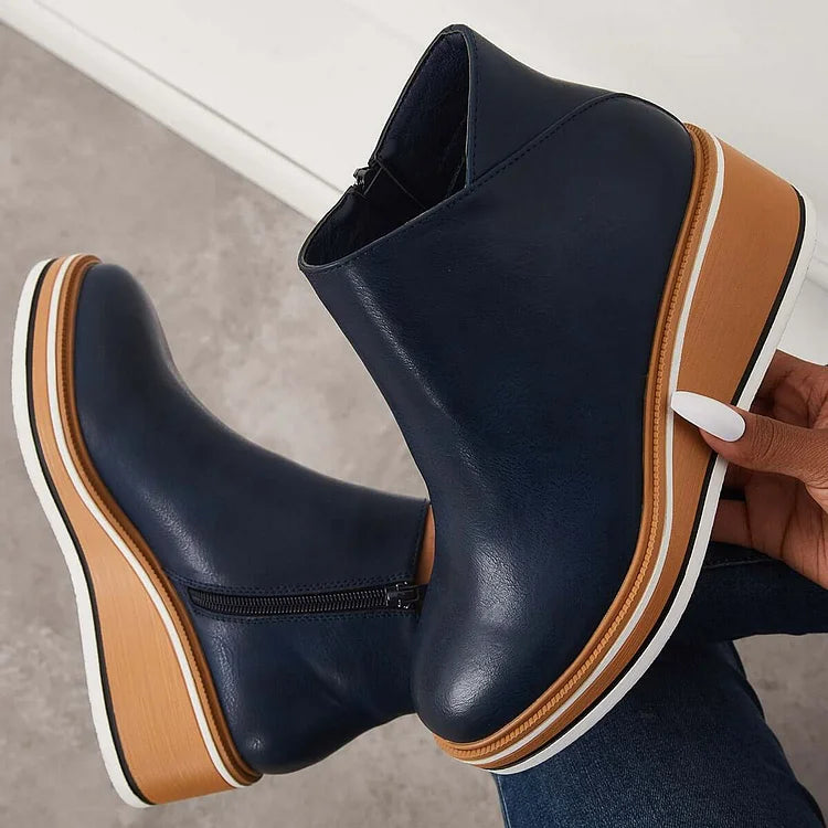 Navy-blue ankle boots with side zipper, tan-and-white platform wedge sole