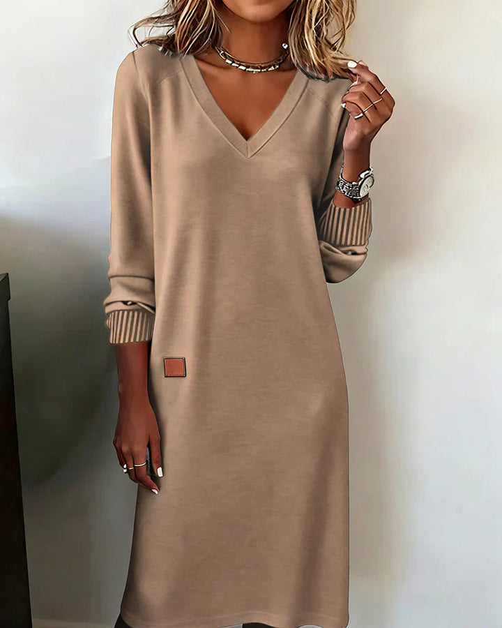 Beige cozy V-neck dress with long sleeves, ribbed cuffs, and small side pocket