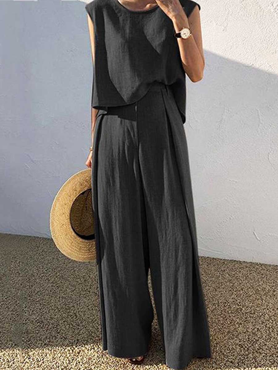 Black sleeveless top and wide-leg pants two-piece set with draped overlay