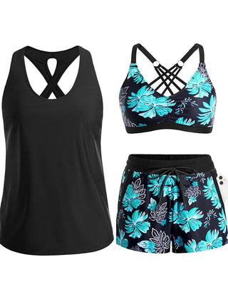 Black tropical swim set with crisscross cutout tank, teal floral bra, and drawstring shorts