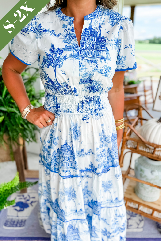 Tiered V-neck maxi dress in white with bold blue toile artwork, short puff sleeves
