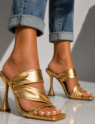 Champagne gold heeled sandals with open toe and twisted front strap