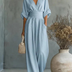 Light blue V-neck wide-leg jumpsuit with tie belt waist and relaxed dolman sleeves