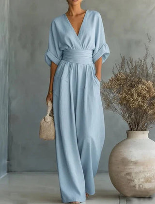 Light blue V-neck wide-leg jumpsuit with tie belt waist and relaxed dolman sleeves