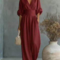 Burgundy V-neck wide-leg jumpsuit with elastic tie waist and loose dolman sleeves