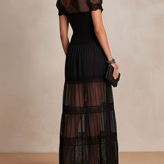 Black maxi dress, short puff sleeves and tiered skirt with lace trim; buttoned bodice