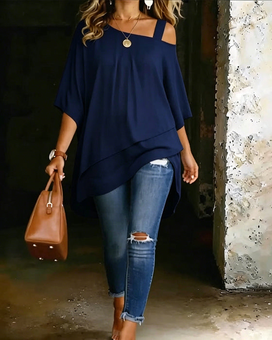 Navy asymmetric blouse with wide square neckline and draped hi-lo hem