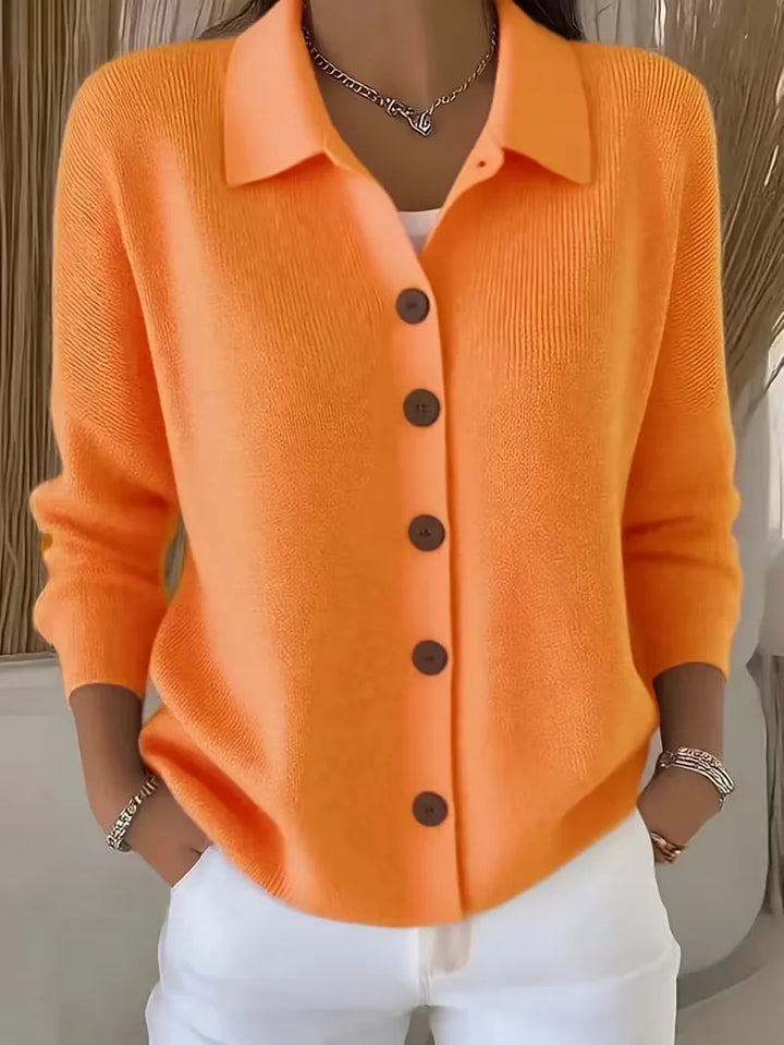 Orange button-front knit cardigan with point collar and dark buttons, long sleeves