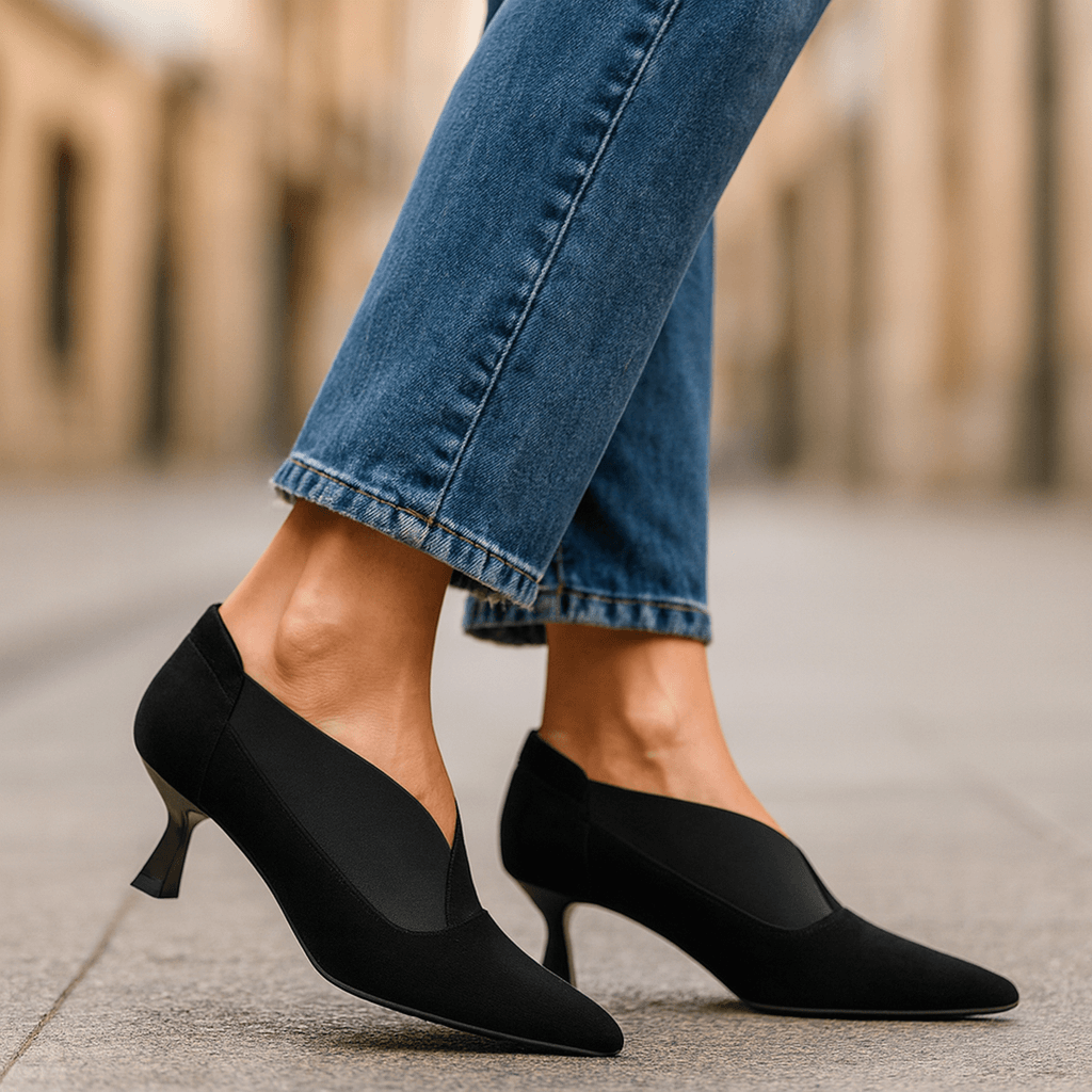 Black suede pointed-toe heeled pumps with slim stiletto heel and side elastic